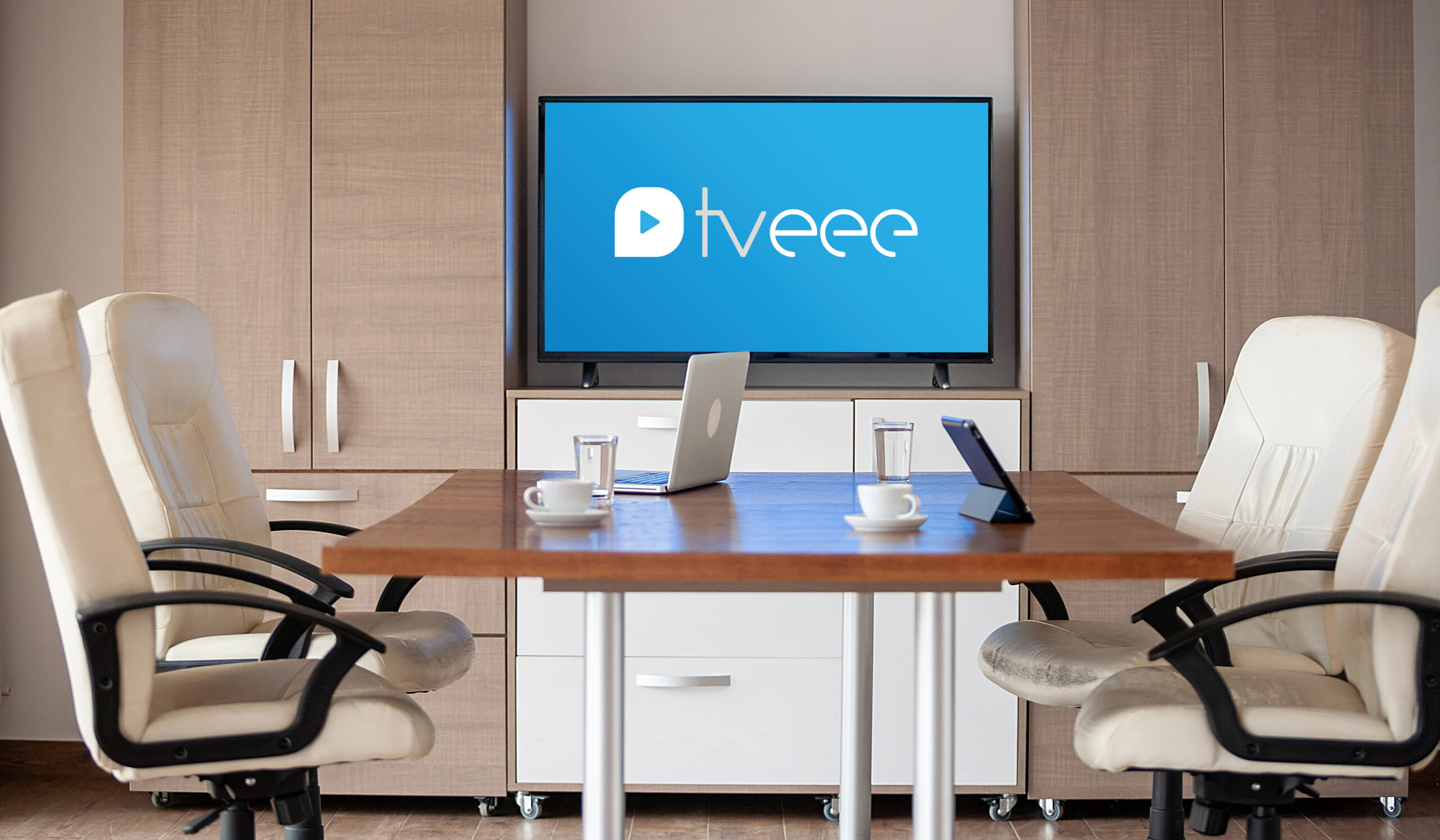 Empty business meeting conference room with graphs and diagrams on TV in the background